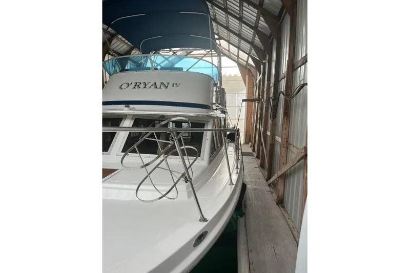 Slide: The Image of 1976 Uniflite 32 Sport Sedan boat docked in a covered marina. - 4