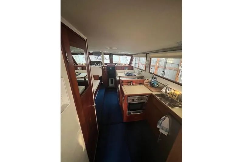 Slide: The Image of 1976 Uniflite 32 Sport Sedan interior with kitchen and seating area. - 40