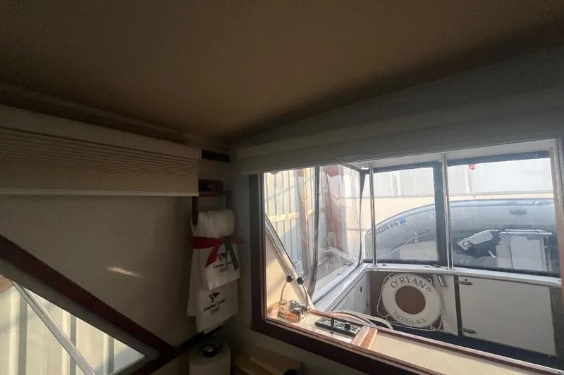 Slide: The Image of Interior view of a 1976 Uniflite 32 Sport Sedan boat with window and life preserver. - 46