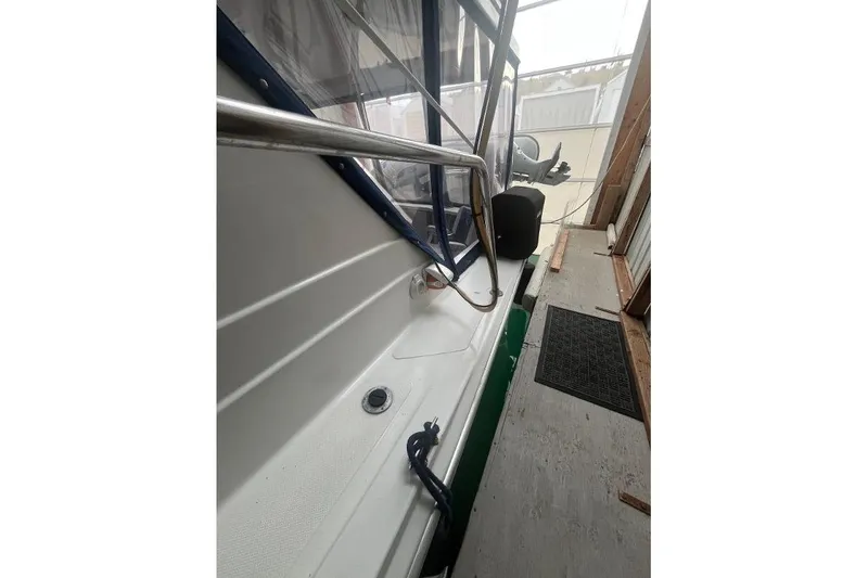 Slide: The Image of 1976 Uniflite 32 Sport Sedan boat docked in a covered area. - 5