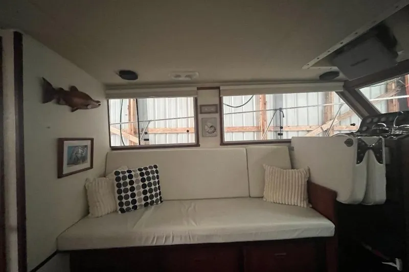 Slide: The Image of Interior of 1976 Uniflite 32 Sport Sedan with white seating and nautical decor. - 52