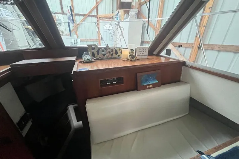 Slide: The Image of 1976 Uniflite 32 Sport Sedan interior with decor and seating in a boat cabin. - 55