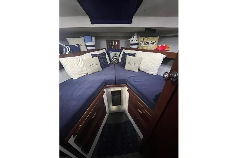 Slide: The Image of 1976 Uniflite 32 Sport Sedan cabin with cozy bedding and decorative pillows. - 56