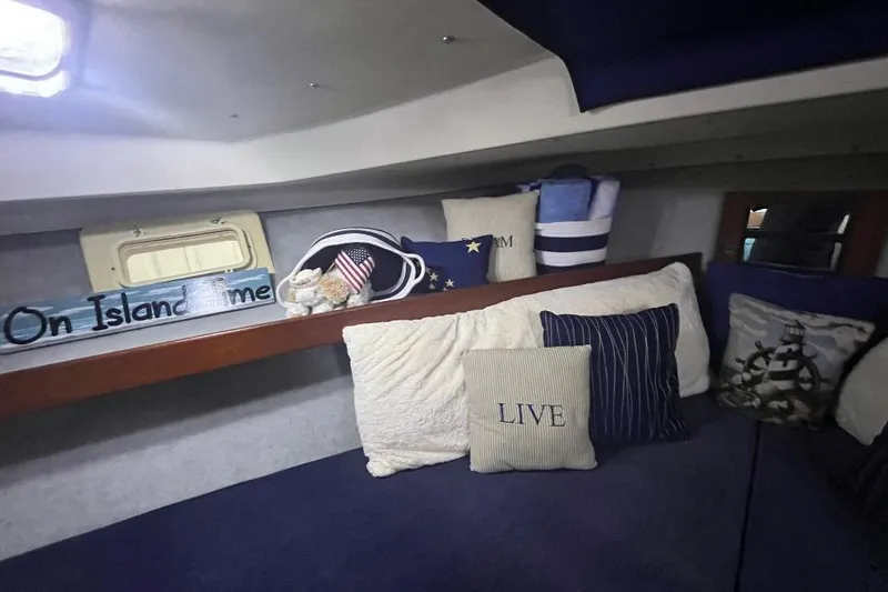 Slide: The Image of Cozy interior of 1976 Uniflite 32 Sport Sedan with nautical-themed decor and pillows. - 59