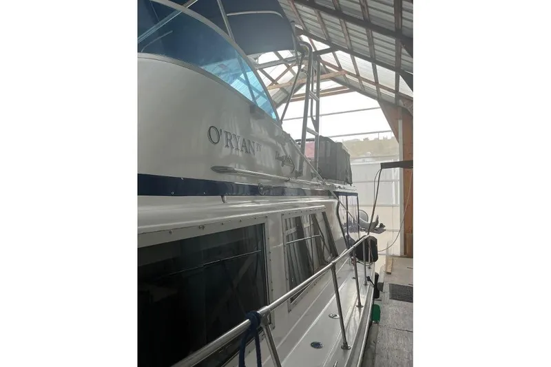 Slide: The Image of 1976 Uniflite 32 Sport Sedan docked in a covered marina. - 6