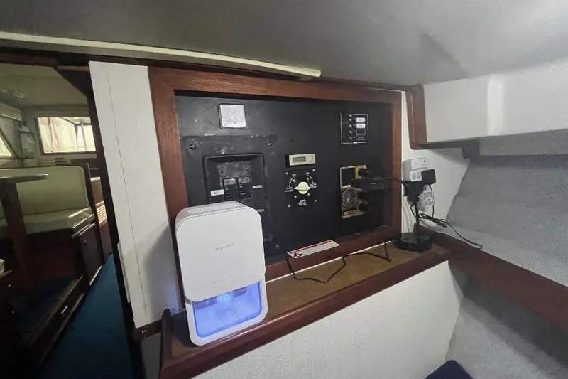 Slide: The Image of 1976 Uniflite 32 Sport Sedan interior with control panel and dehumidifier. - 60