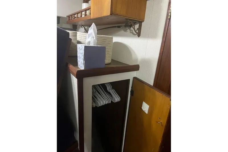 Slide: The Image of 1976 Uniflite 32 Sport Sedan interior with closet, hangers, and tissue box. - 63