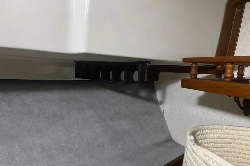 Slide: The Image of 1976 Uniflite 32 Sport Sedan interior with wooden shelf and storage compartment. - 64