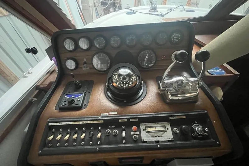 Slide: The Image of 1976 Uniflite 32 Sport Sedan dashboard with gauges, controls, and compass. - 67