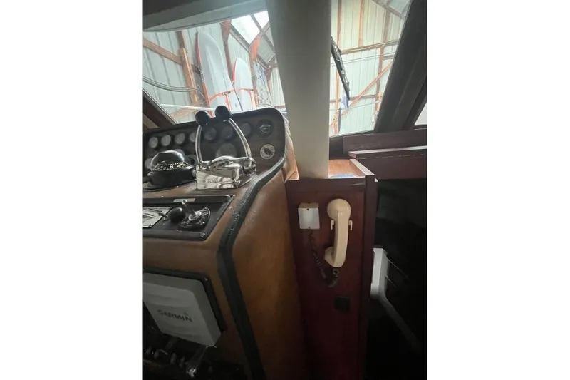 Slide: The Image of 1976 Uniflite 32 Sport Sedan helm with vintage controls and telephone in cabin. - 68