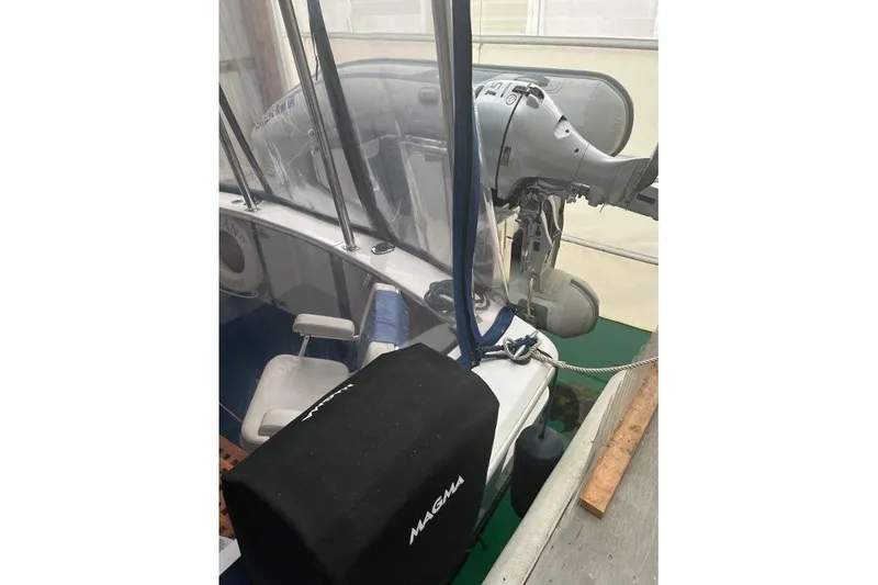 Slide: The Image of 1976 Uniflite 32 Sport Sedan with outboard motor and covered seating area. - 7