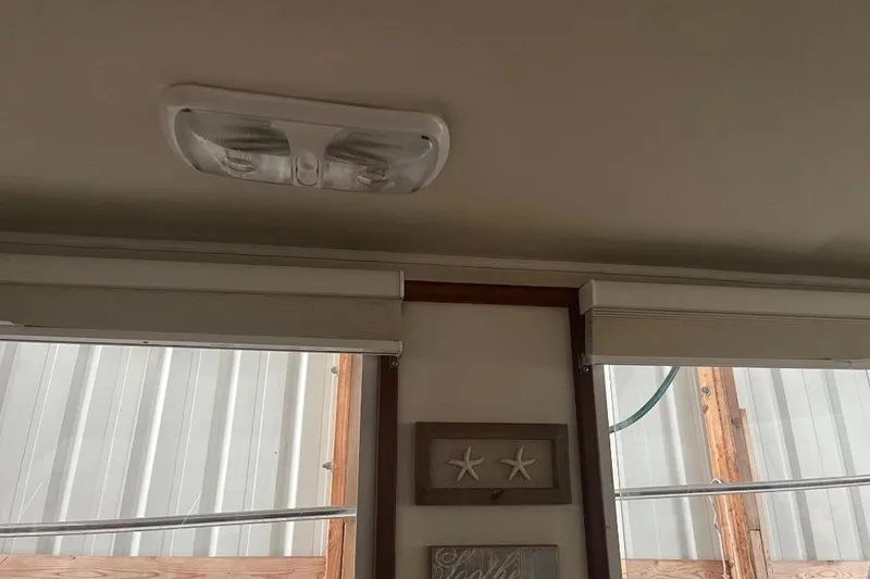 Slide: The Image of Interior of 1976 Uniflite 32 Sport Sedan with ceiling light and window blinds. - 74