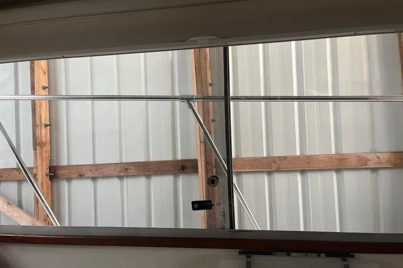 Slide: The Image of Interior view of a 1976 Uniflite 32 Sport Sedan window with metal framing. - 76