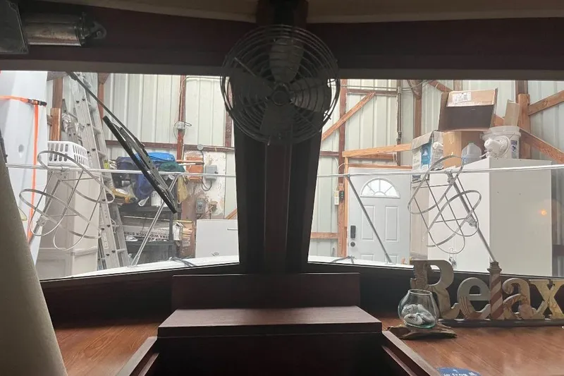 Slide: The Image of Interior view of a 1976 Uniflite 32 Sport Sedan boat in a storage shed. - 77