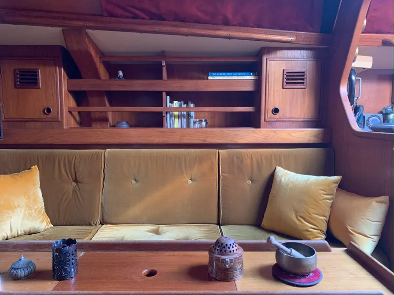 Slide: The Image of Cozy interior of 1980 Nautor Swan 371 yacht with wooden shelves and mustard cushions. - 15