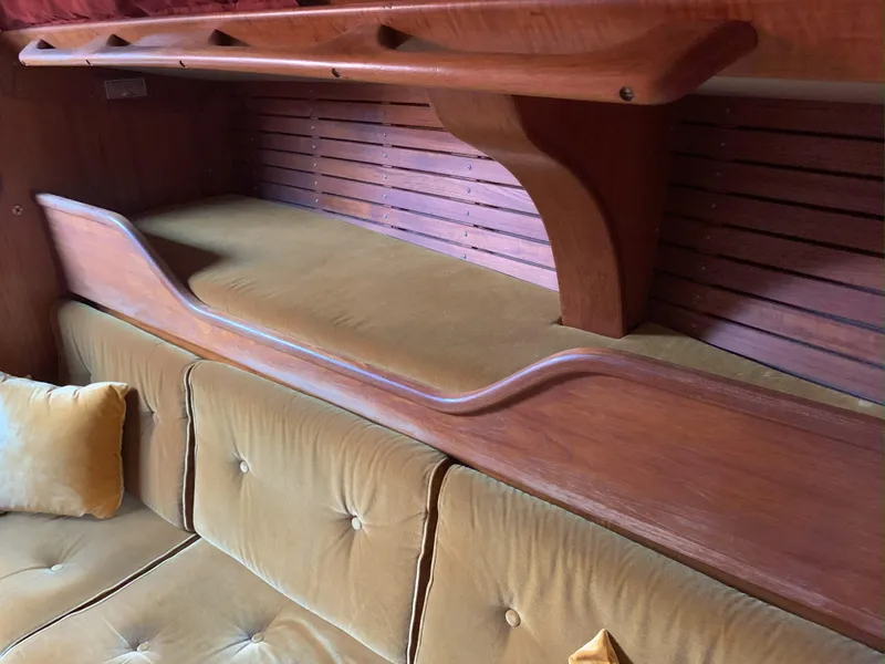 Slide: The Image of Interior of 1980 Nautor Swan 371 yacht with wooden shelves and cushioned seating. - 17