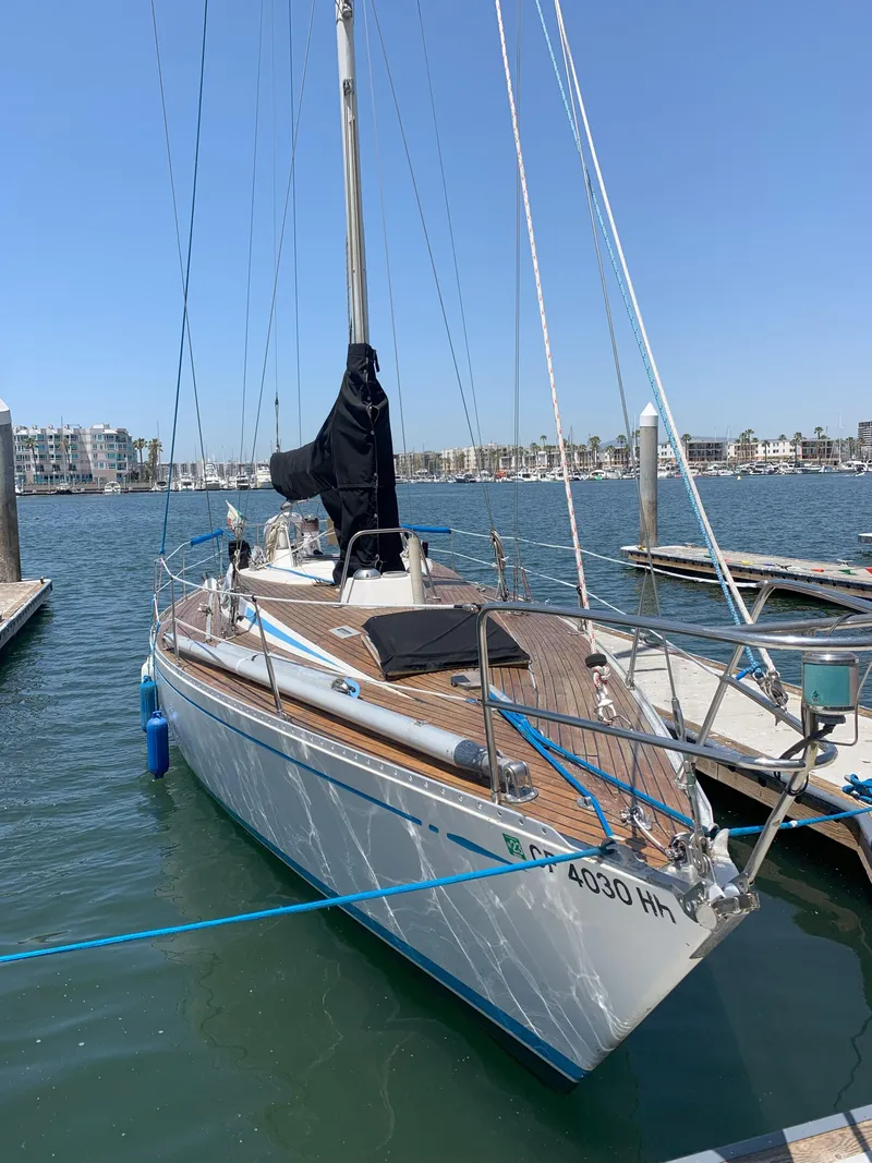 Slide: The Image of 1980 Nautor Swan 371 sailboat docked in marina under clear blue sky. - 2