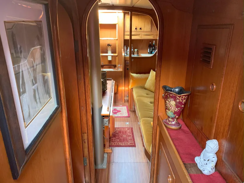 Slide: The Image of Interior of 1980 Nautor Swan 371 yacht with wooden decor and cozy seating area. - 23