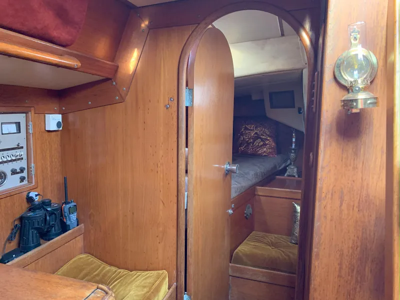 Slide: The Image of Interior of 1980 Nautor Swan 371 yacht with wooden paneling and cozy cabin. - 26