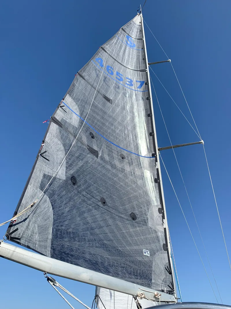 Slide: The Image of Sail of a 1980 Nautor Swan 371 yacht against a clear blue sky. - 27