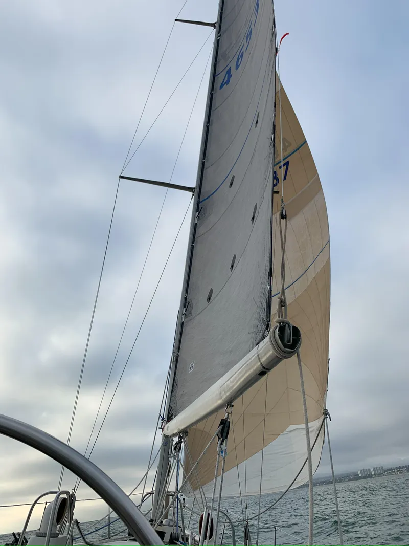 Slide: The Image of Sailing yacht Nautor Swan 371 from 1980 with sails unfurled on a cloudy day. - 28