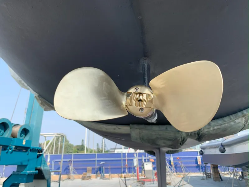 Slide: The Image of Propeller of 1980 Nautor Swan 371 sailboat in dry dock, showcasing polished blades. - 30