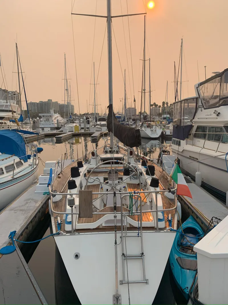 Slide: The Image of 1980 Nautor Swan 371 yacht docked in a marina at sunset. - 6