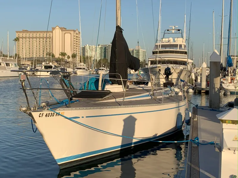Slide: The Image of 1980 Nautor Swan 371 sailboat docked in marina, surrounded by other boats and buildings. - 7