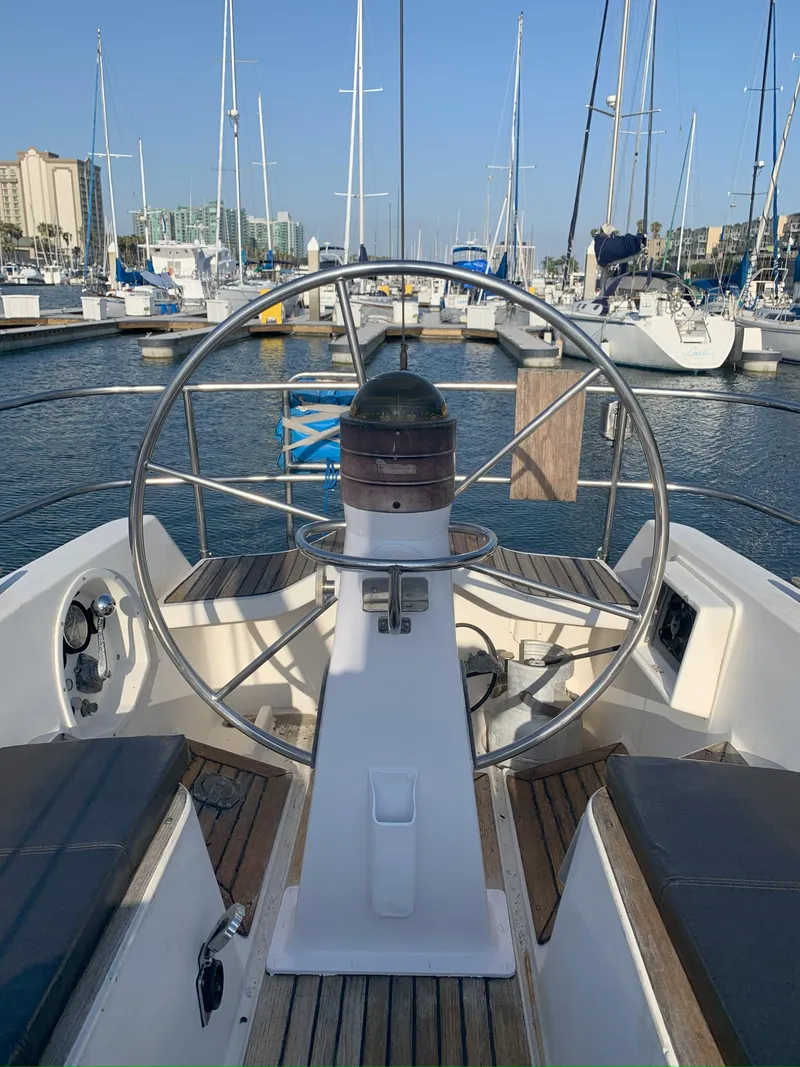 Slide: The Image of Cockpit view of a 1980 Nautor Swan 371 sailboat docked in a marina. - 8