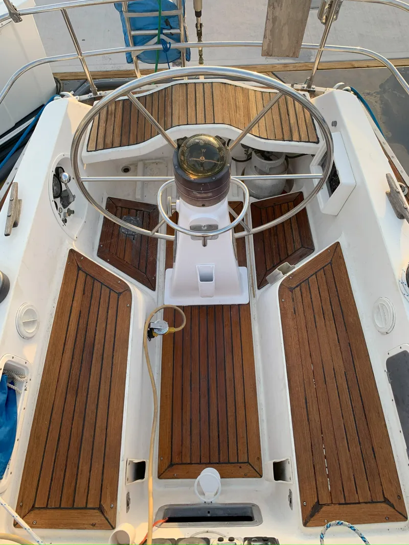 Slide: The Image of Cockpit of 1980 Nautor Swan 371 sailboat with wooden seating and steering wheel. - 9