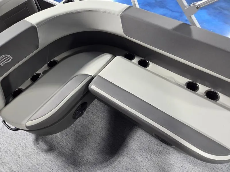 Slide: The Image of 2026 Sun Tracker BB 18 DLX boat seating with cup holders, featuring gray upholstery. - 10