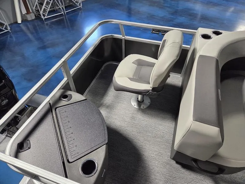 Slide: The Image of 2026 Sun Tracker BB 18 DLX boat interior with seating and table. - 11