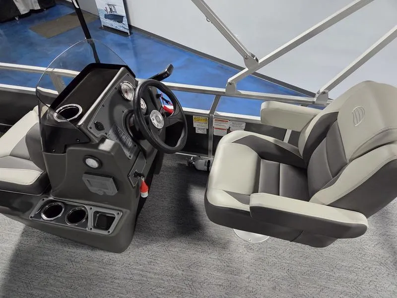 Slide: The Image of 2026 Sun Tracker BB 18 DLX boat interior with steering console and comfortable seating. - 12