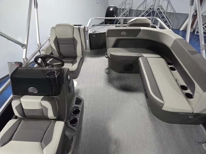 Slide: The Image of 2026 Sun Tracker BB 18 DLX pontoon boat interior with gray seating and steering console. - 13