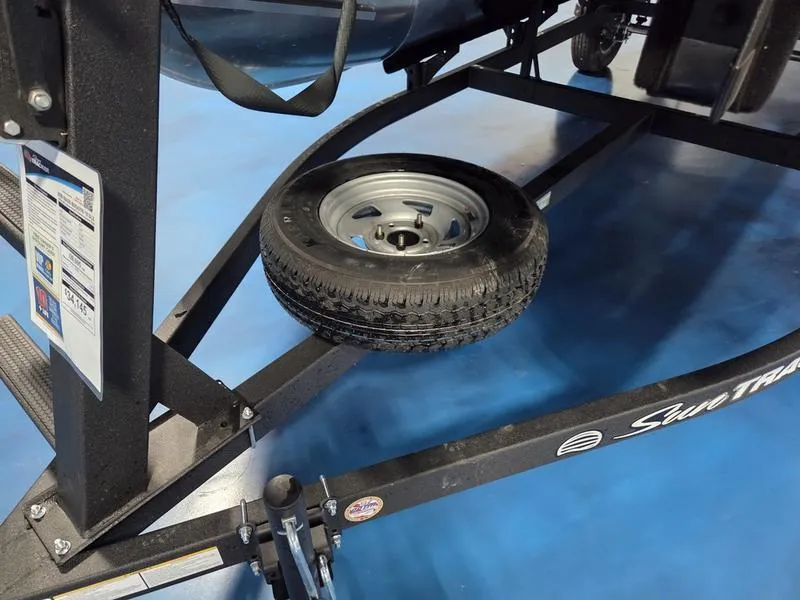 Slide: The Image of 2026 Sun Tracker BB 18 DLX trailer with spare tire on blue floor. - 14