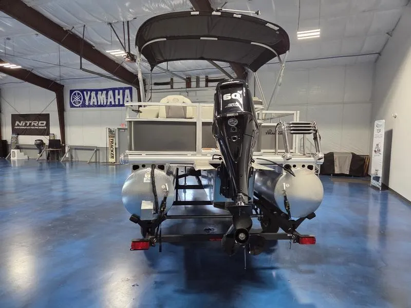 Slide: The Image of 2026 Sun Tracker BB 18 DLX pontoon boat with 60 HP engine in showroom. - 5