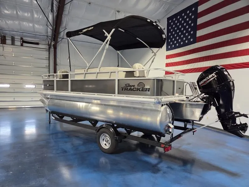 Slide: The Image of 2026 Sun Tracker BB 18 DLX pontoon boat with Mercury engine in a garage. - 7