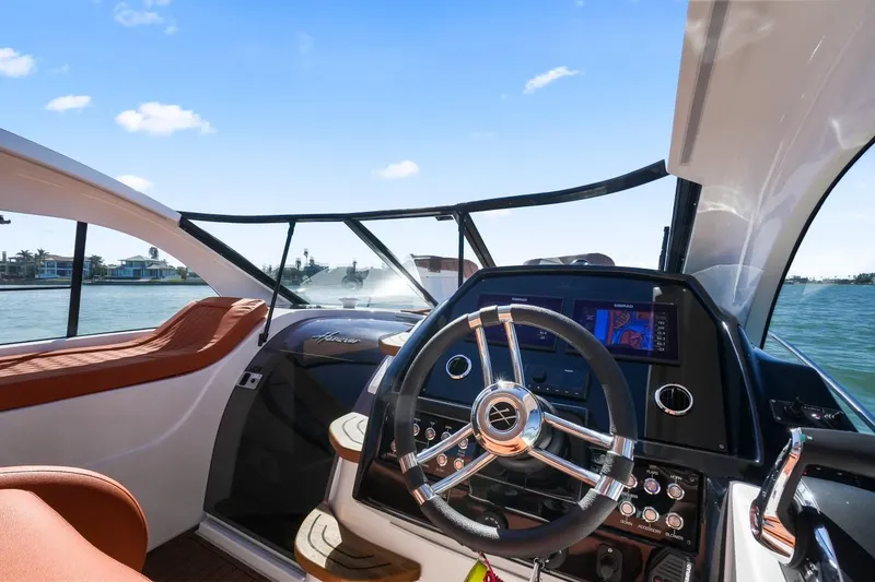 Slide: The Image of 2025 Hanover 355 Outboard boat interior with modern steering and navigation system. - 12
