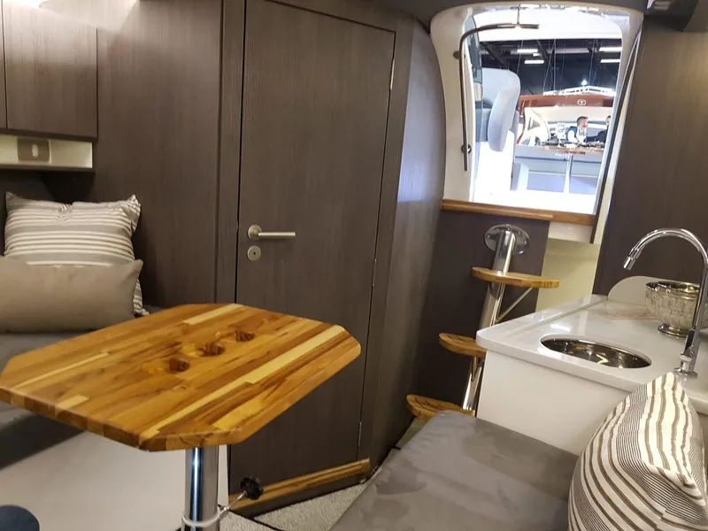 Slide: The Image of Interior of 2025 Hanover 355 Outboard boat with modern kitchen and seating area. - 22