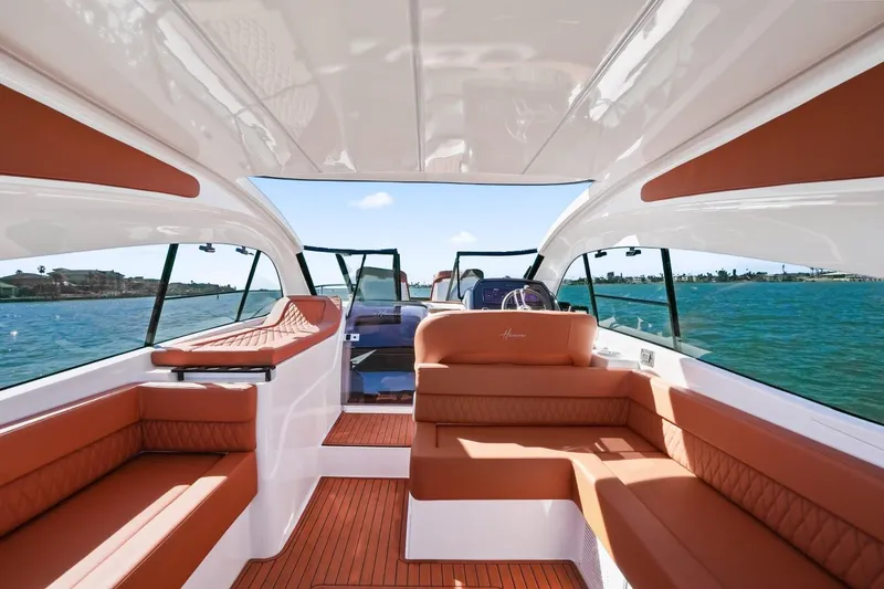 Slide: The Image of 2025 Hanover 355 Outboard boat interior with luxurious seating and scenic water view. - 7