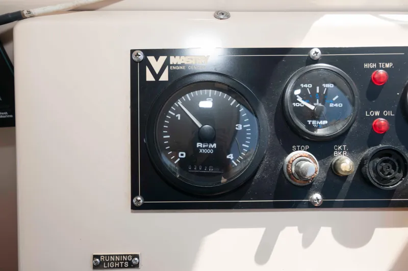 Slide: The Image of Control panel of a 2005 Atlas Boat Works Acadia 25, featuring RPM and temperature gauges. - 11