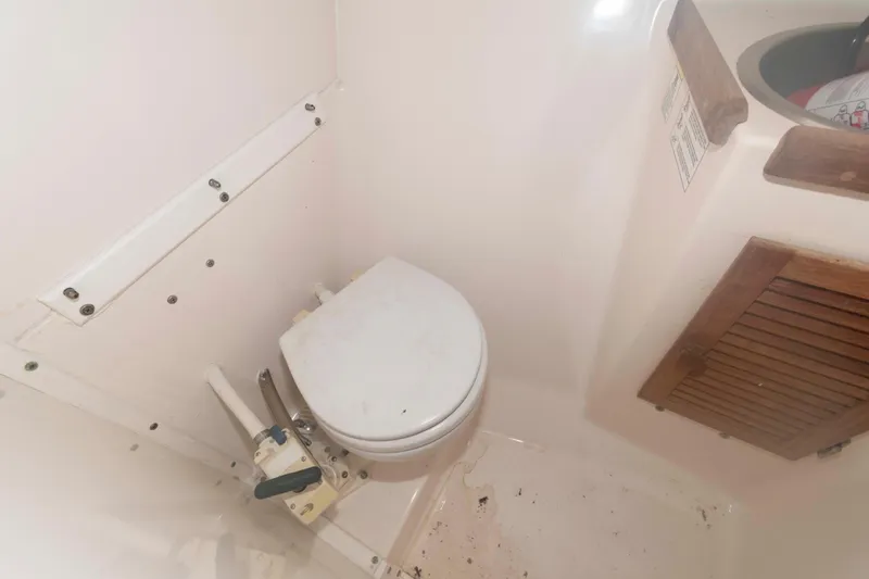 Slide: The Image of 2005 Atlas Boat Works Acadia 25 marine toilet and sink area. - 13