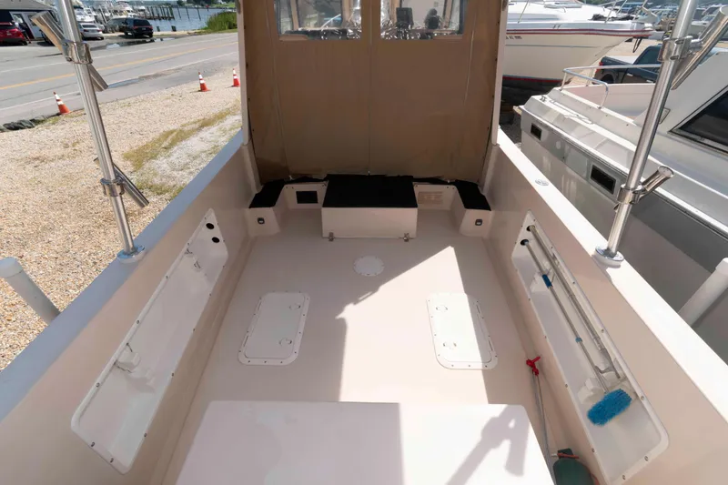 Slide: The Image of 2005 Atlas Boat Works Acadia 25 interior with seating and storage compartments. - 5