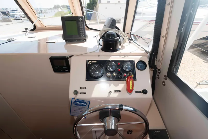 Slide: The Image of 2005 Atlas Boat Works Acadia 25 helm with navigation instruments and steering wheel. - 9