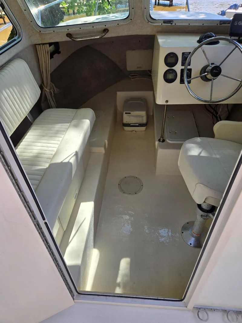 Slide: The Image of 2003 Parker 2120 Sport Cabin interior with seating, steering wheel, and dashboard controls. - 5