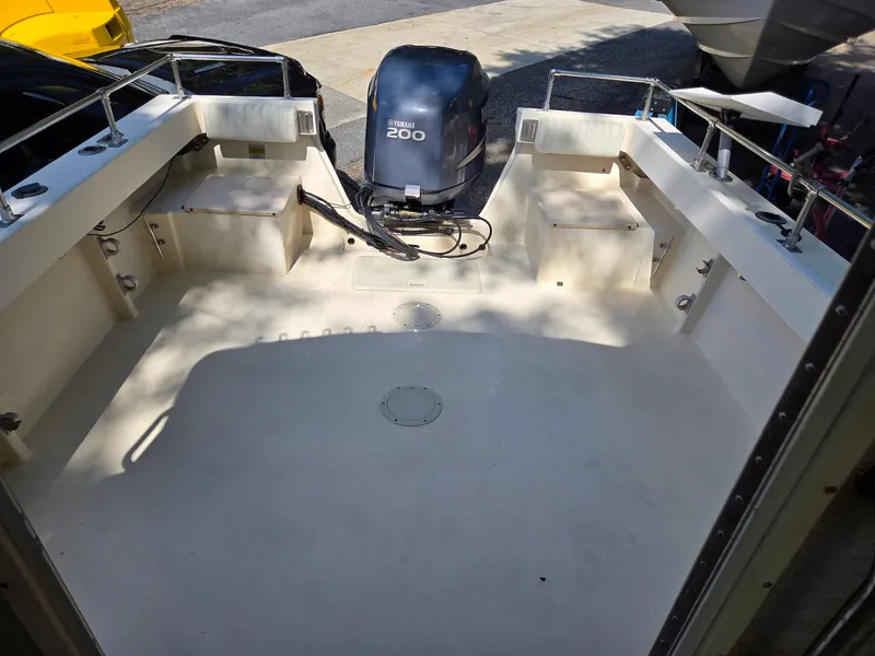 Slide: The Image of 2003 Parker 2120 Sport Cabin boat interior with Yamaha 200 outboard motor. - 6
