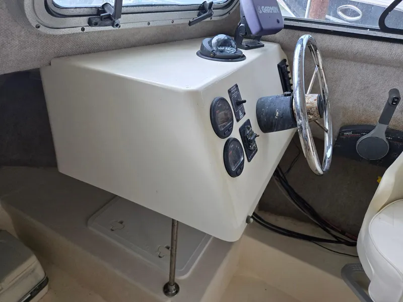 Slide: The Image of 2003 Parker 2120 Sport Cabin boat dashboard with steering wheel and gauges. - 7