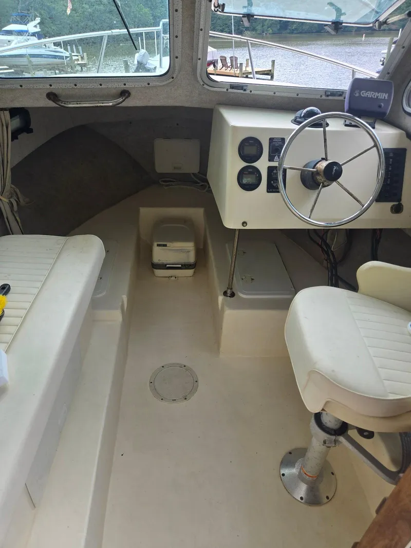 Slide: The Image of 2003 Parker 2120 Sport Cabin interior with steering wheel and seating. - 8