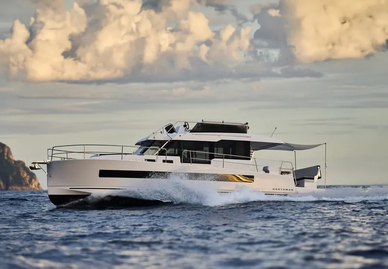 Slide: The Image of 2025 Northman 1300 yacht cruising on open water under a cloudy sky. - 6