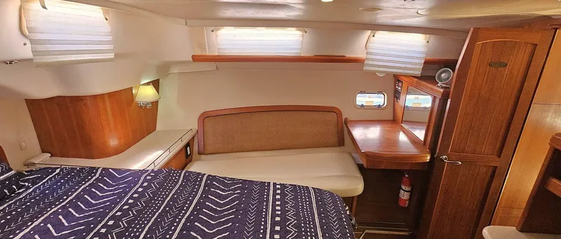 Slide: The Image of Interior of 2007 Hunter 45 Center Cockpit yacht with cozy cabin and wooden furnishings. - 10